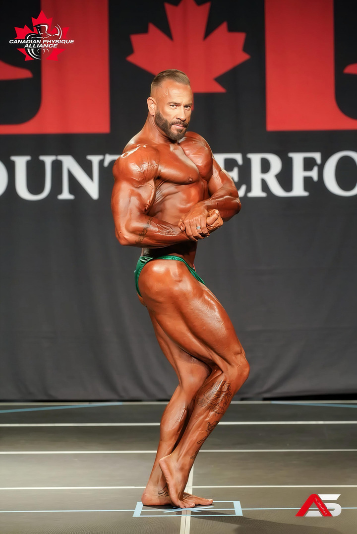Benjamin Huber on stage at a bodybuilding competition