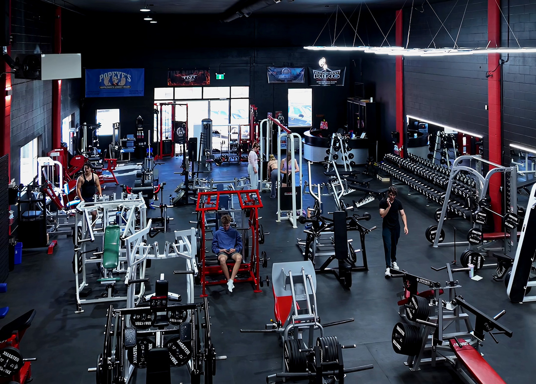 The main machine floor at Legacy Athletix, racks and plate loaded machines down both sides
