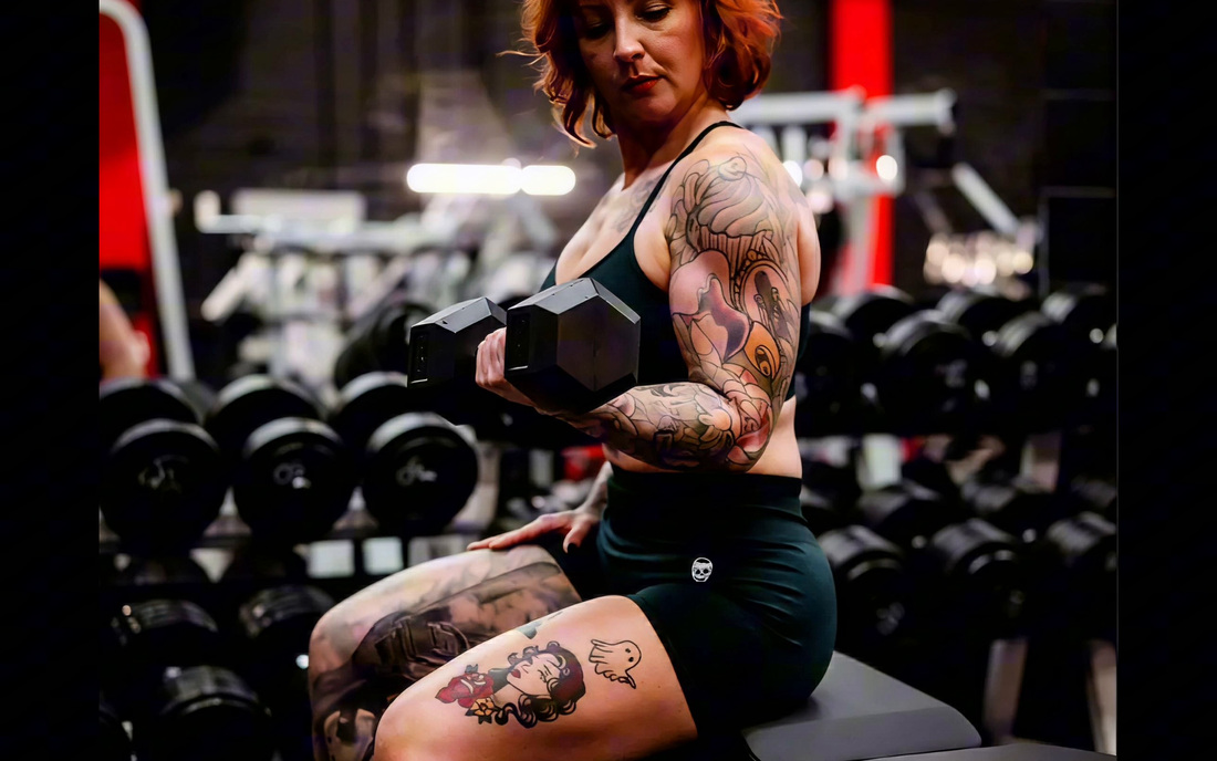 A member curling a dumbbell beside the dumbbell rack at Legacy Athletix